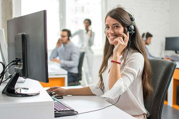 female customer service representative smiling on the phone